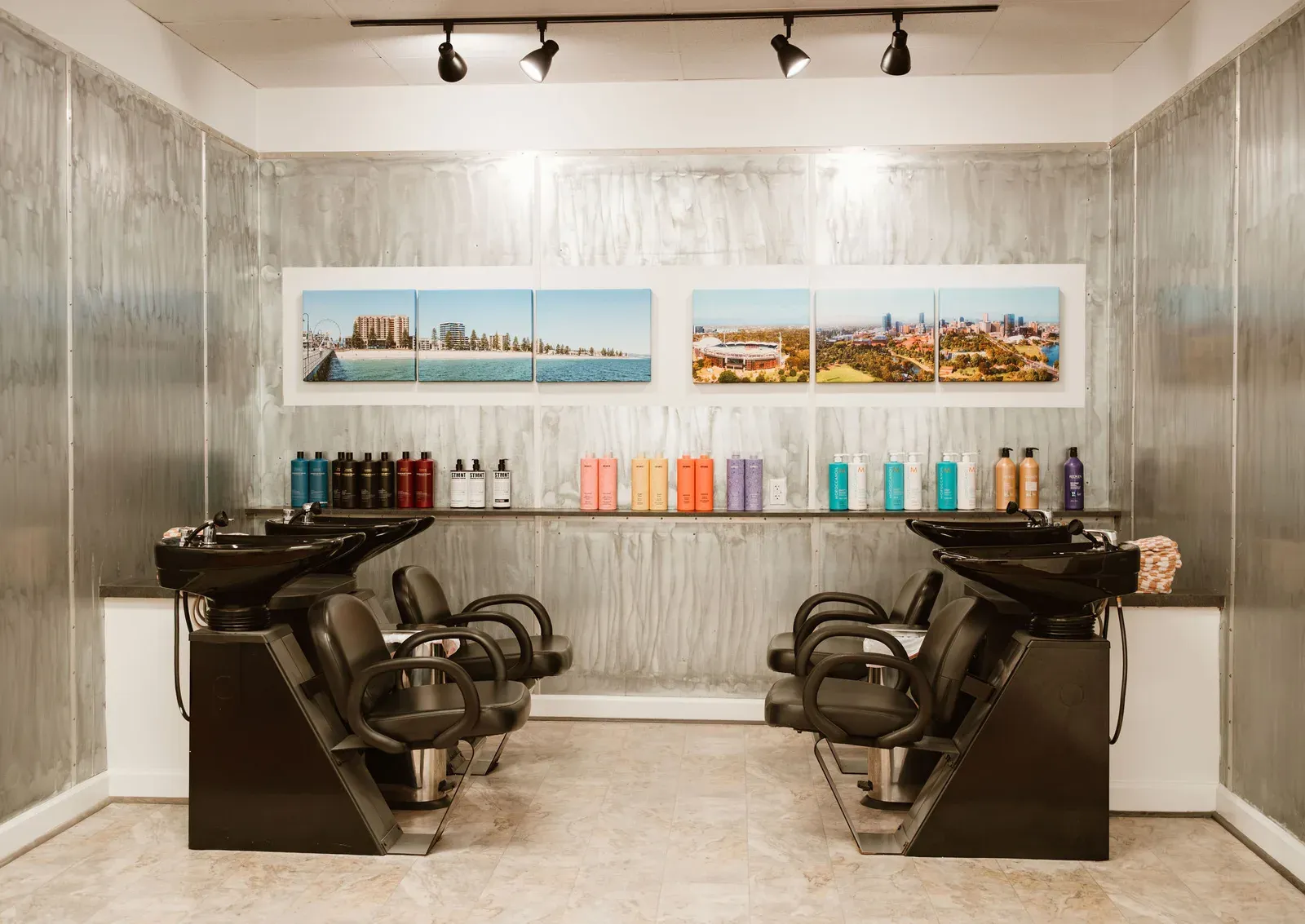 The shampoo area with panoramic prints of Adelaide, Australia above it