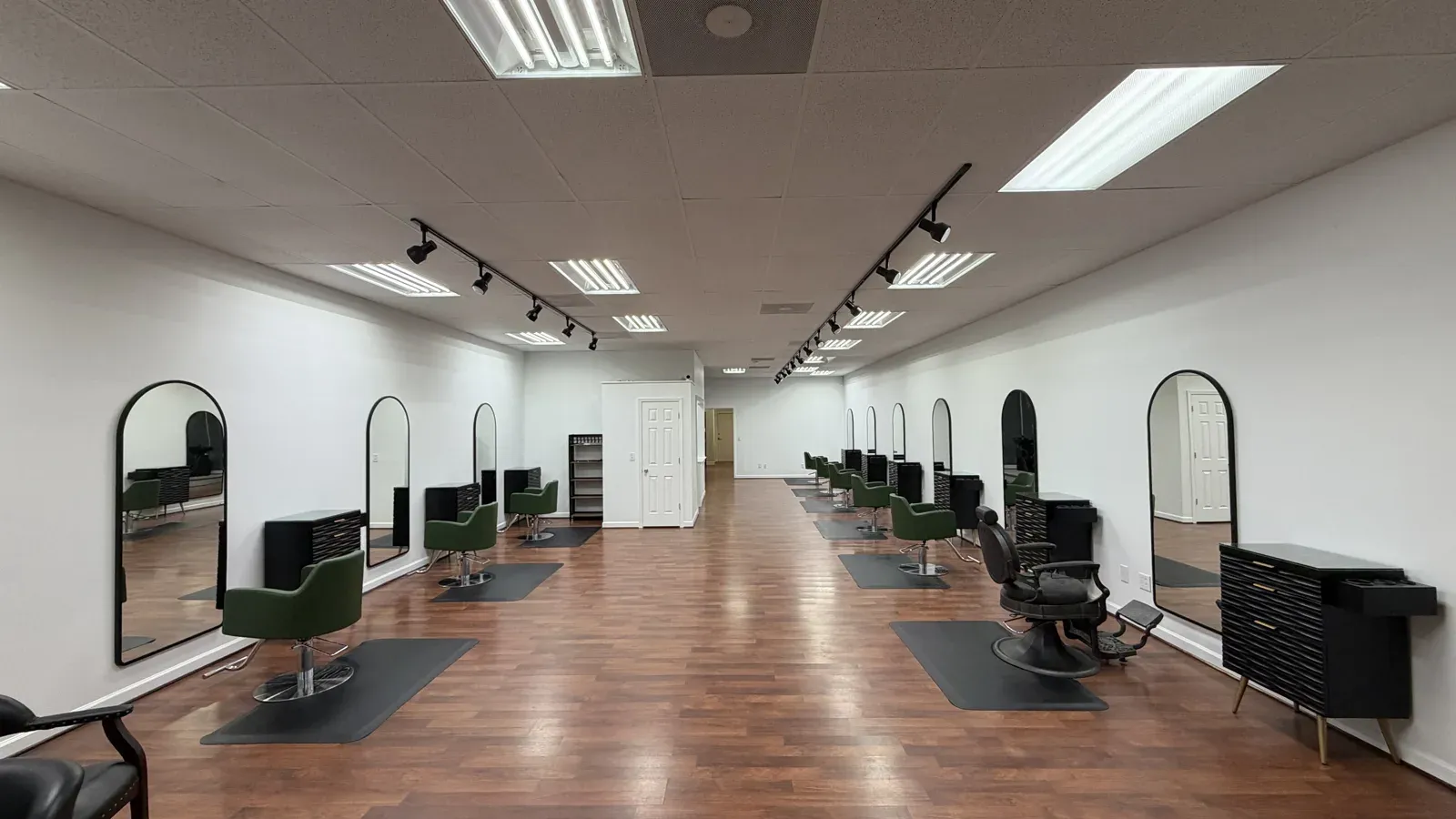 The first arched mirrors and green chairs installed in the empty room