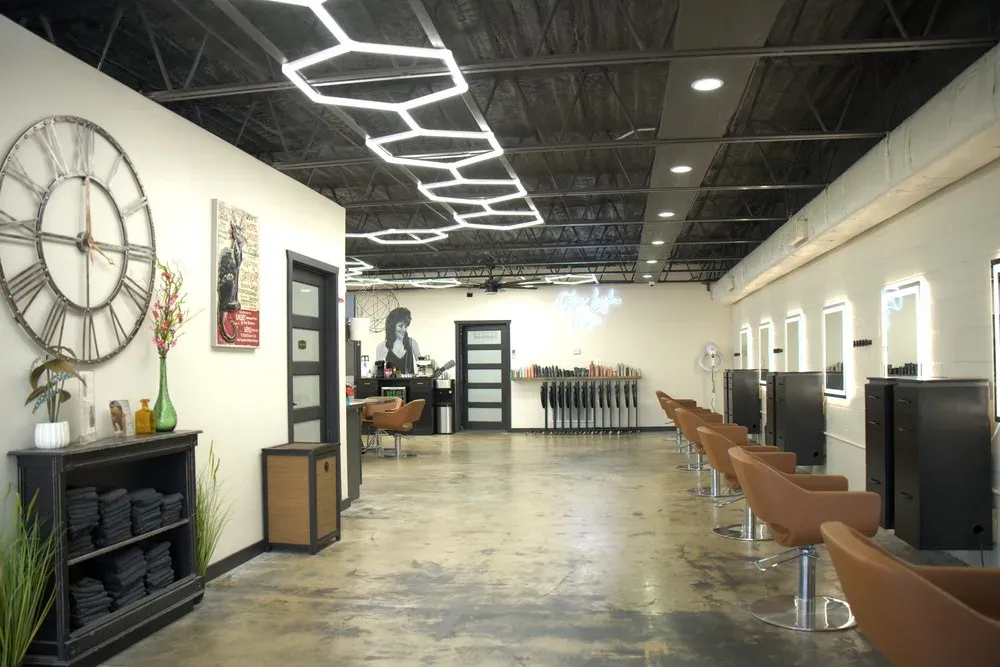 Polished concrete floor and mirrors down the length of the salon